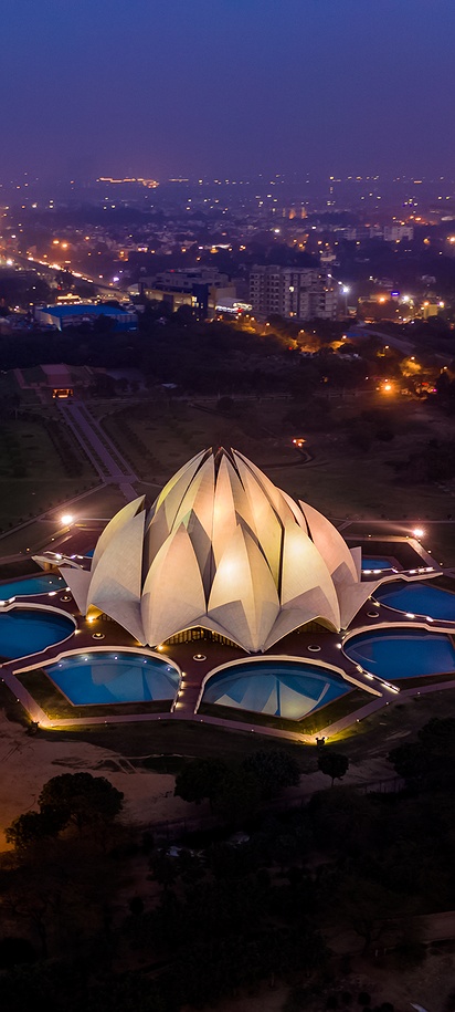 a scenic aerial night view of the Lotus Temple in New Delhi, India