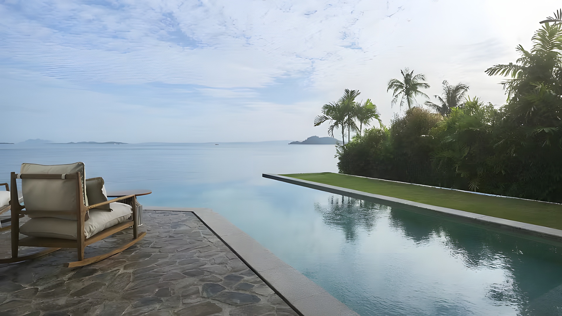 a luxury infinity pool overlooking a calm ocean of the Barceló Coconut Island resort in Phuket, Thailand