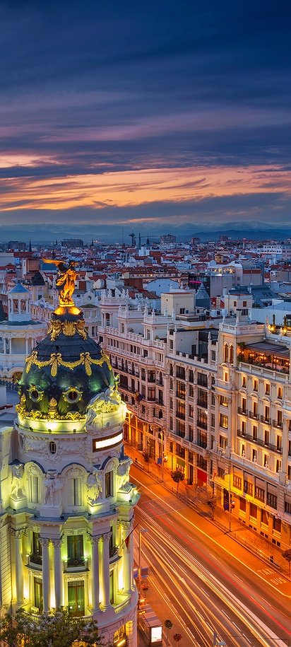 Evening city lights on Gran Vía and Metropolis Building in Madrid