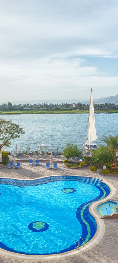 the swimming pool and Nile River view from the Steigenberger Nile Palace Luxor hotel in Egypt
