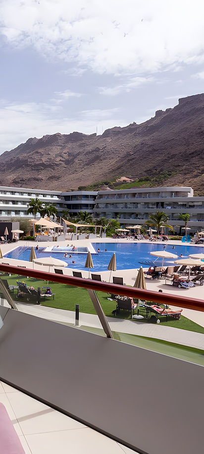 a view from a balcony overlooking the swimming pool at the Radisson Blu Resort & Spa, Gran Canaria Mogan