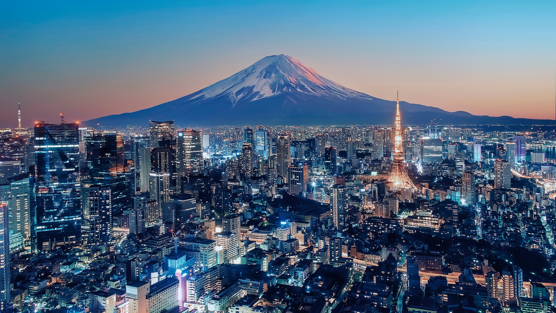 stunning panoramic view of the Tokyo skyline at sunset, with Mount Fuji