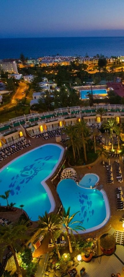 an aerial night view of the Gloria Palace San Agustin Thalasso & Hotel located in Gran Canaria, Spain