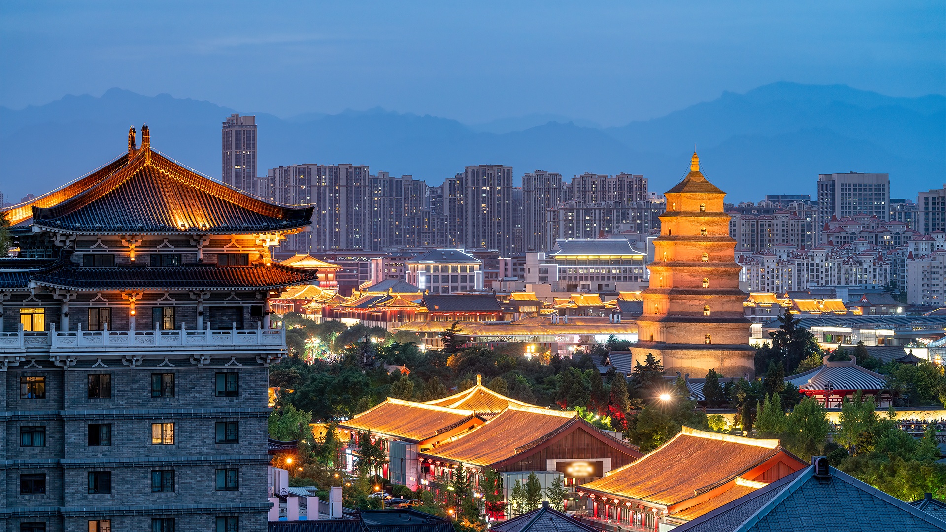 a scenic view of the Giant Wild Goose Pagoda and surrounding structures in Xi'an, China, during twilight