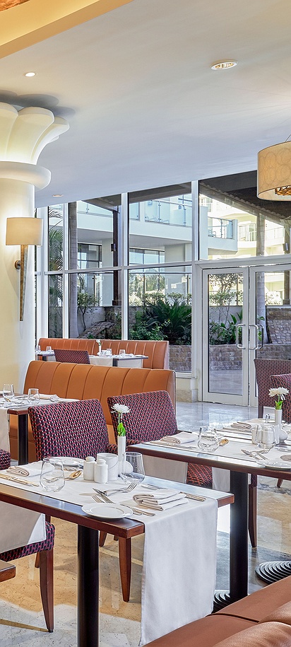 the interior dining area of a restaurant of the Lotus Main Restaurant & Terrace at the Steigenberger Pyramids Cairo hotel