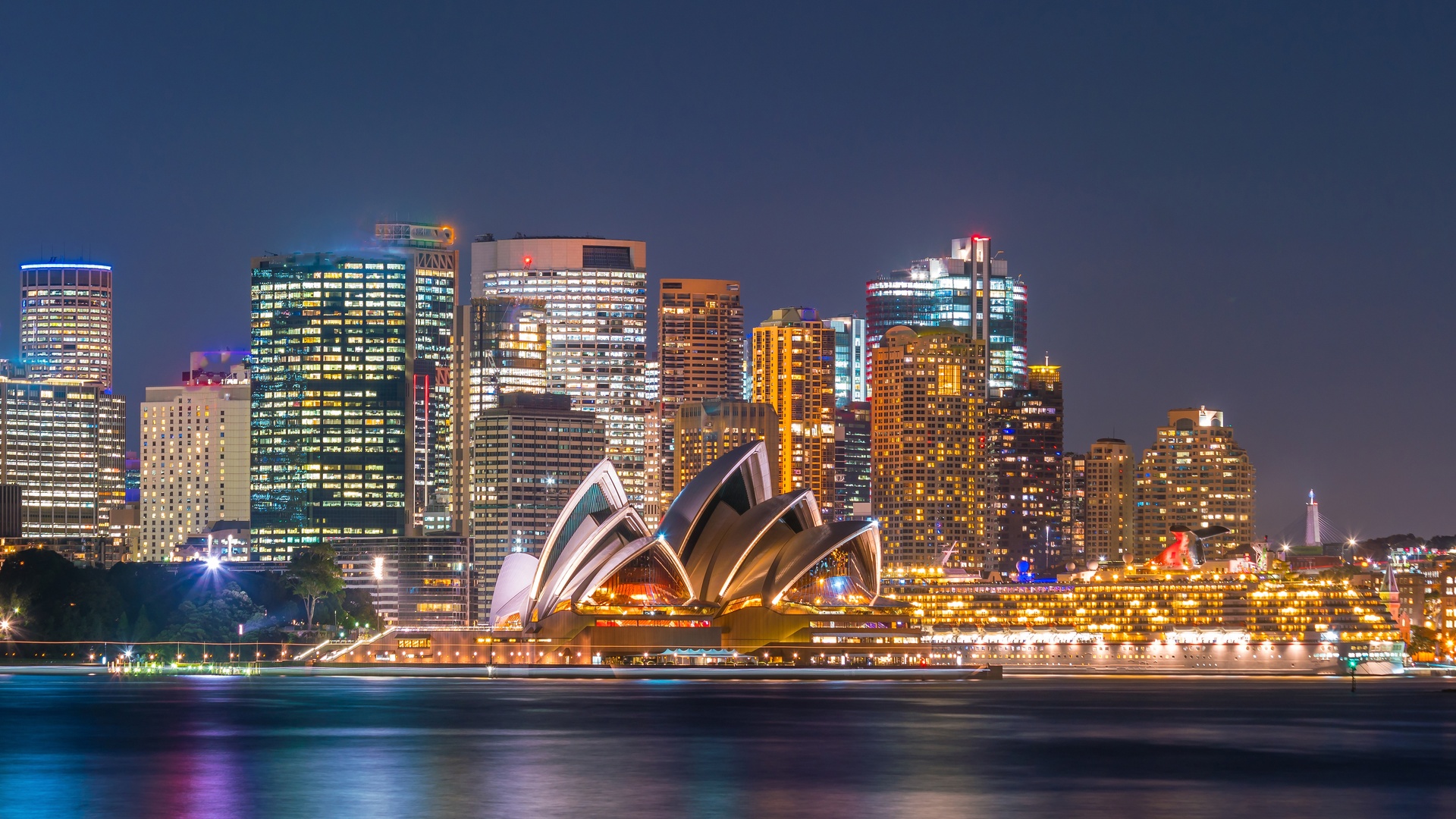 the Sydney Opera House and the surrounding Sydney skyline at night