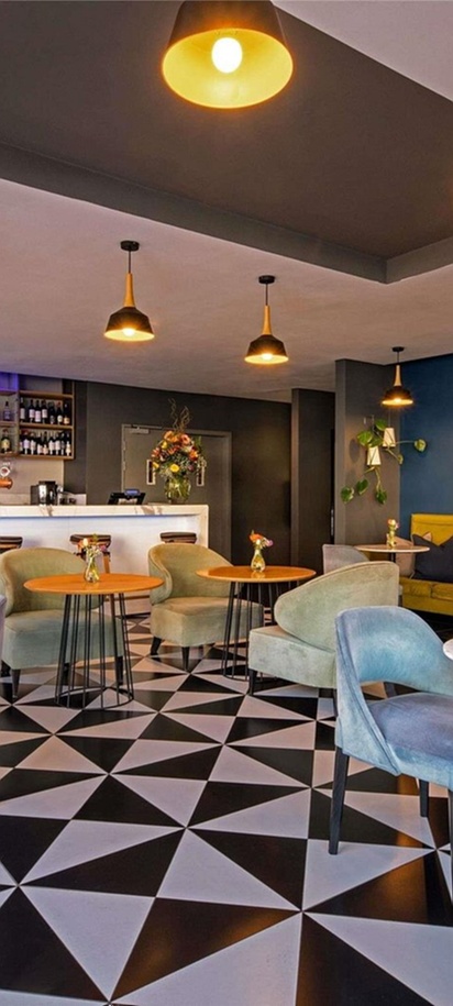the interior of a bar and lounge area located at the Pullman Cape Town City Centre hotel.