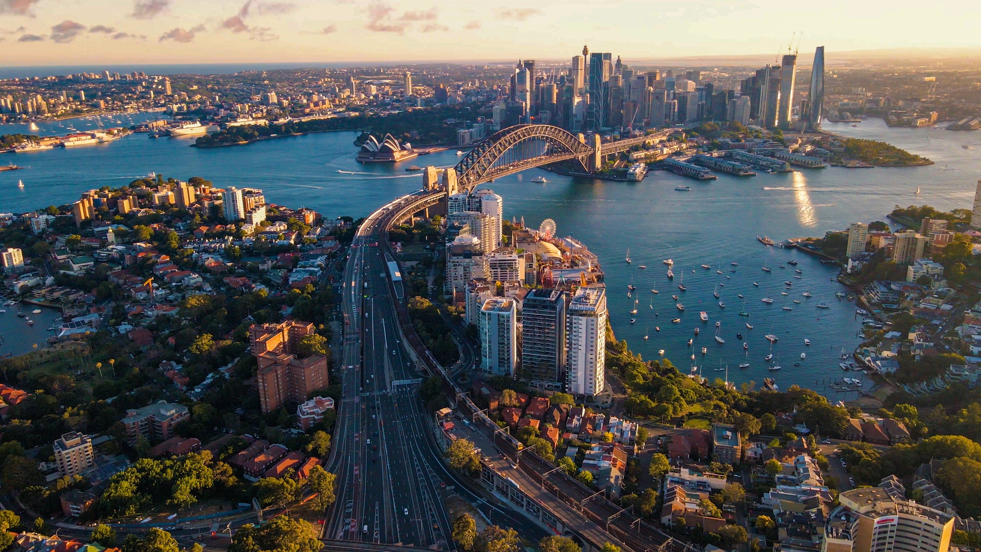 a scenic aerial view of the Sydney Harbour Bridge and the surrounding Sydney Harbour area in Australia