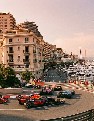 fleet of Formula 1 cars navigating the legendary Fairmont Hairpin (formerly known as the Loews Hairpin) during the Monaco Grand Prix