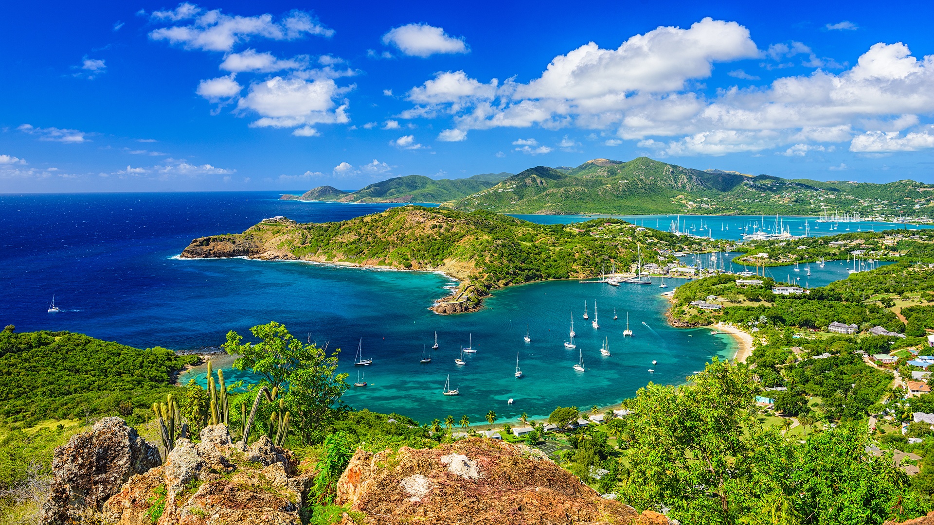 a panoramic view of English Harbour and Falmouth Harbour in Antigua, likely taken from the historic viewpoint at Shirley Heights
