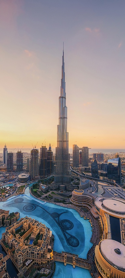 a scenic skyline view of Downtown Dubai featuring the Burj Khalifa during sunset