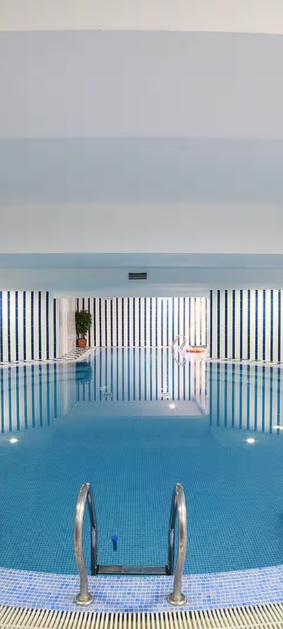 indoor swimming pool area at the Ramada by Wyndham Almaty hotel