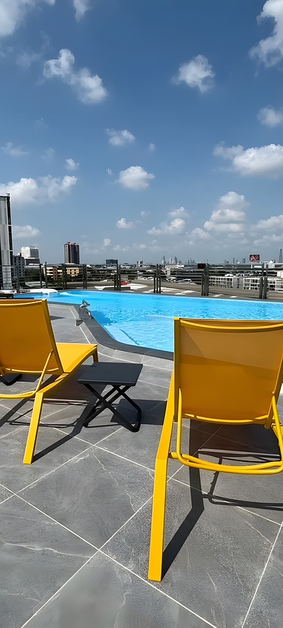 the rooftop infinity pool area at the Lumen Bangkok Udomsuk Station hotel