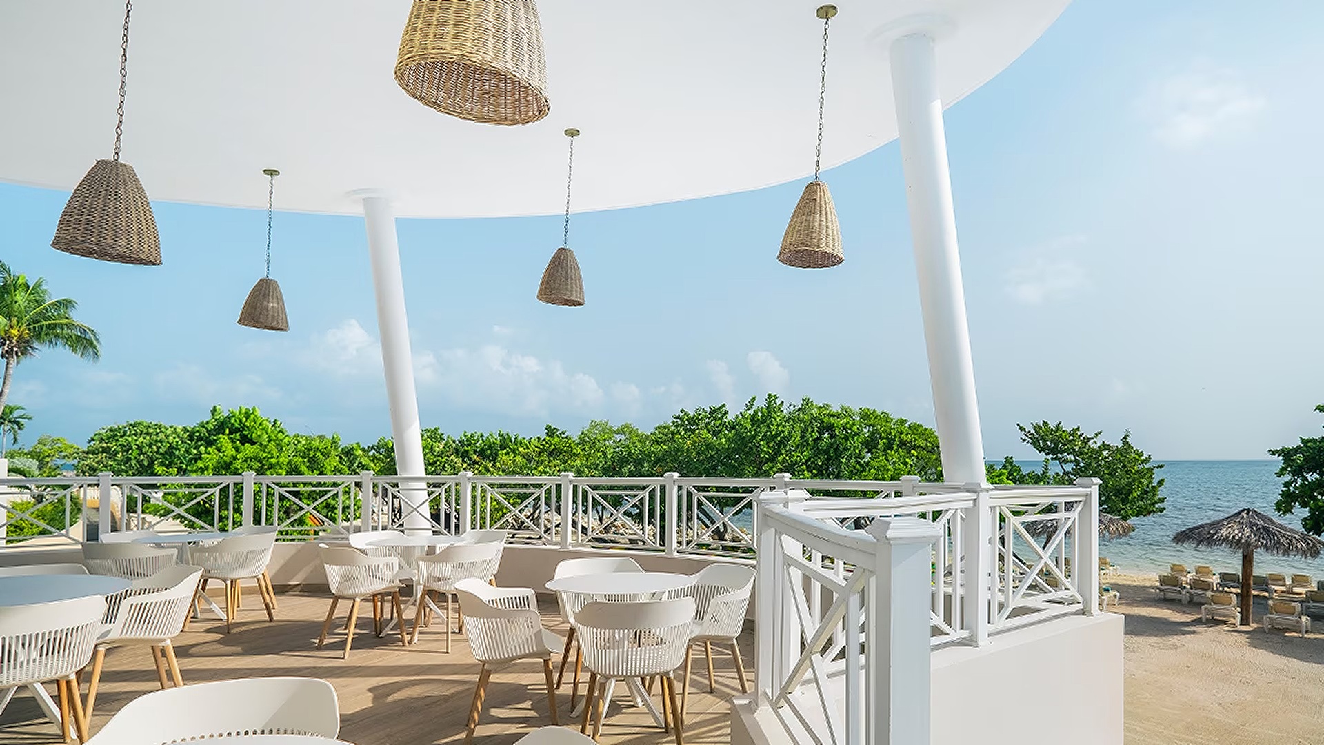 an outdoor dining or lounge terrace at the Iberostar Waves Rose Hall Beach resort in Montego Bay, Jamaica