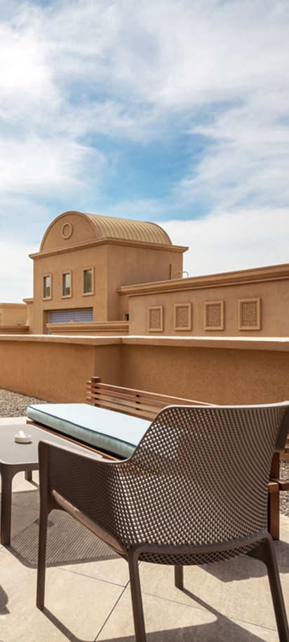 a rooftop terrace furnished with modern patio furniture at the Karavansaray Turkistan Family Hotel.