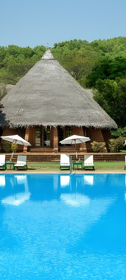 the swimming pool and main building at SwaSwara Wellness Retreat, a hotel managed by CGH Earth located on Om Beach in Gokarna, Karnataka, India