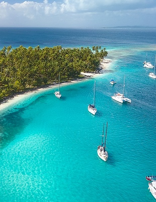 a drone aerial view of sailboats anchored of the San Blas Islands in Panama