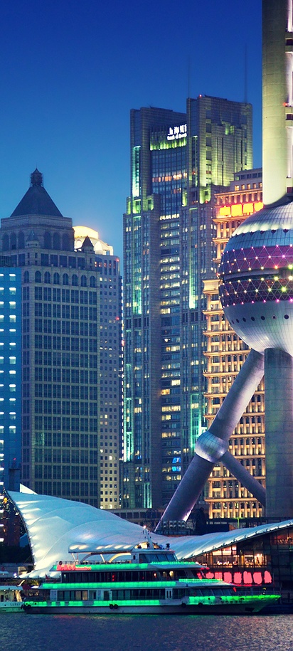 the Shanghai skyline, featuring the iconic Oriental Pearl Tower along the Huangpu River