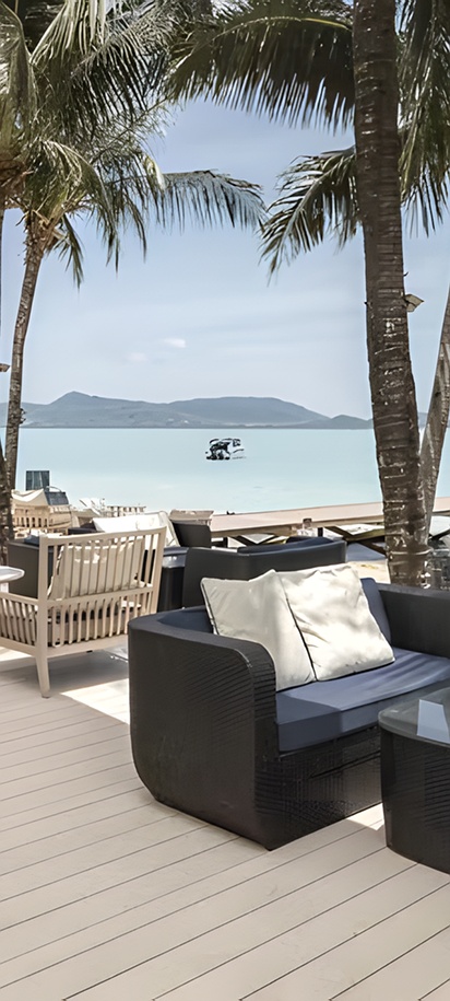 the beachfront bar and seating area at the Barceló Coconut Island resort in Phuket, Thailand