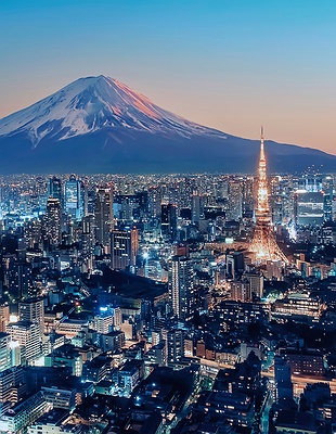 stunning panoramic view of the Tokyo skyline at sunset, with Mount Fuji