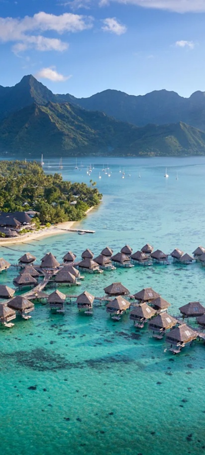 Overwater villas and turquoise lagoon with mountain views