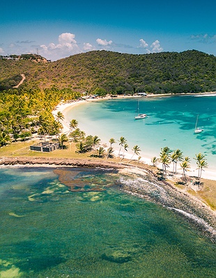a scenic view of the Mandarin Oriental, Canouan resort located on the island of Canouan in St. Vincent and the Grenadines