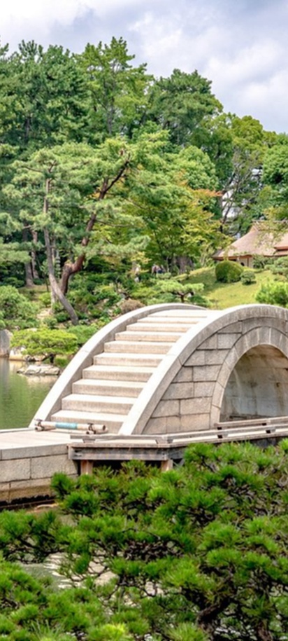 the Kokokyo Bridge, also known as the "Rainbow Bridge," located within Shukkeien Garden in Hiroshima, Japan