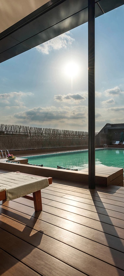 the outdoor swimming pool and sun terrace at the Novotel Shanghai Clover hotel