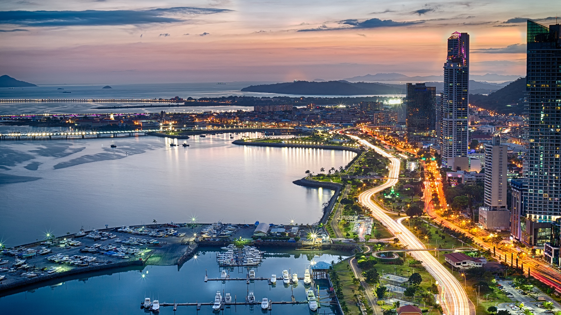 a scenic sunset view of the Panama City skyline and bay, likely featuring the Avenida Balboa area