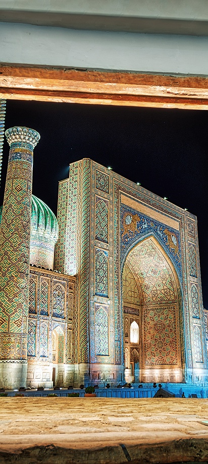 view from inside a doorway looking out at Registan Square in Samarkand, Uzbekistan