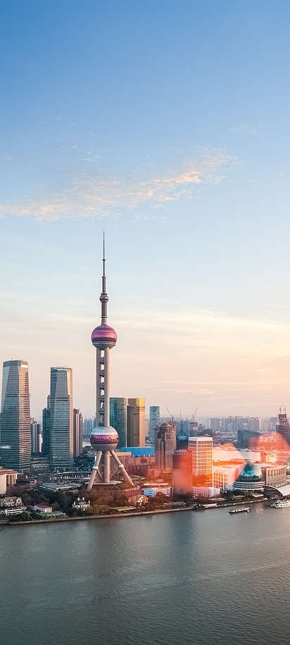 the Lujiazui skyline in Shanghai, China, along the Huangpu River during sunset