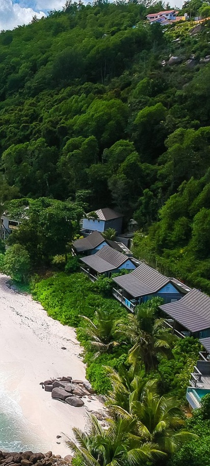 Tropical beach with forest and villas at Carana Beach