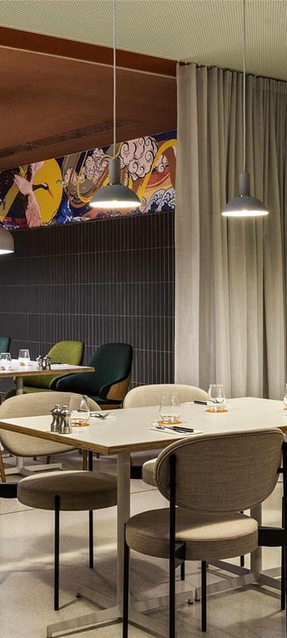 the dining area of the Umami Burger restaurant located inside the Pullman Paris Montparnasse hotel