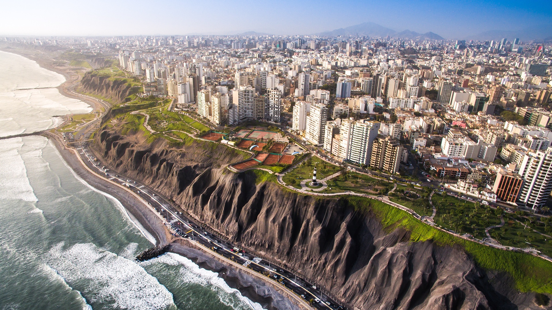 a scenic aerial view of the Miraflores Cliffs and the surrounding cityscape in Lima, Peru