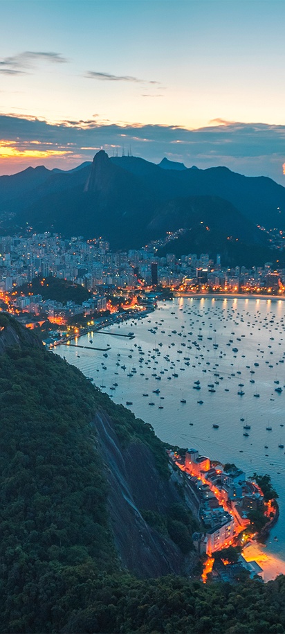 a scenic view of Sugarloaf Mountain in Rio de Janeiro, Brazil, at sunset