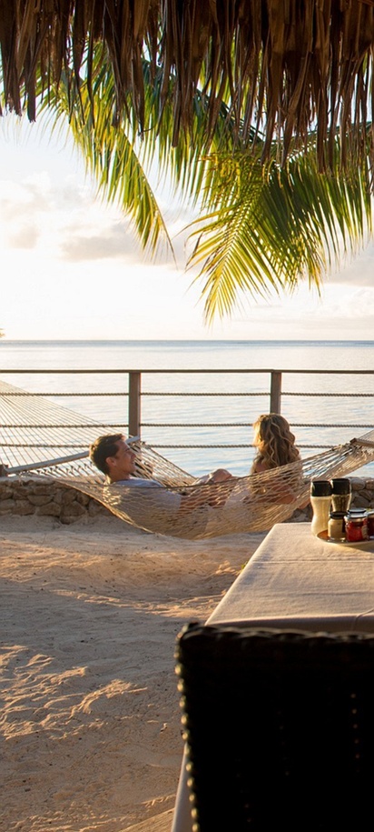Couple relaxing in a hammock by the beach