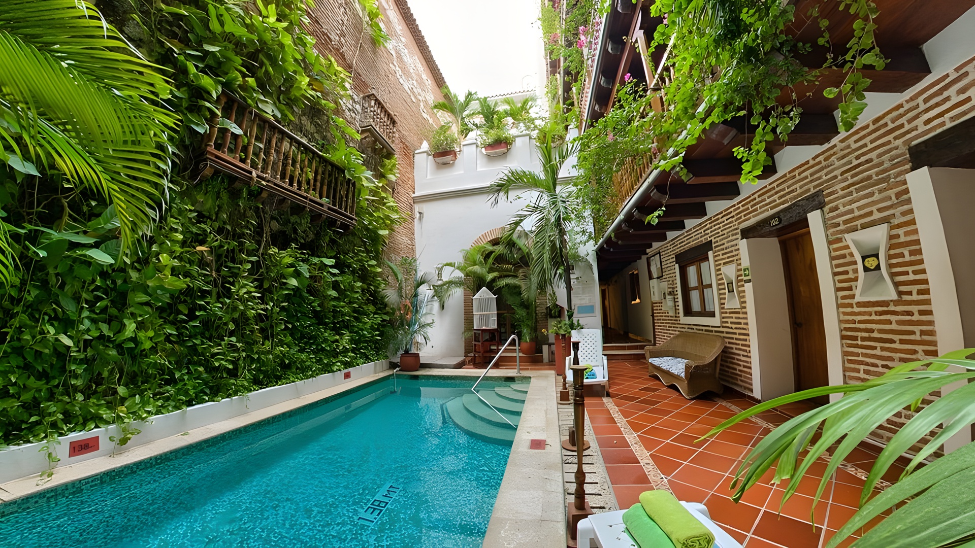 the central courtyard and swimming pool of the Hotel Don Pedro de Heredia, located in the historical center of Cartagena, Colombia