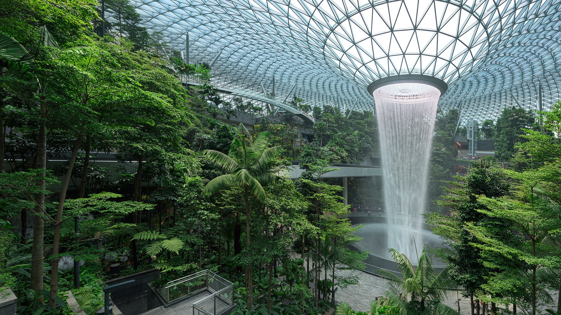 the Jewel Changi Airport in Singapore, specifically featuring the HSBC Rain Vortex, which is the world's tallest indoor waterfall