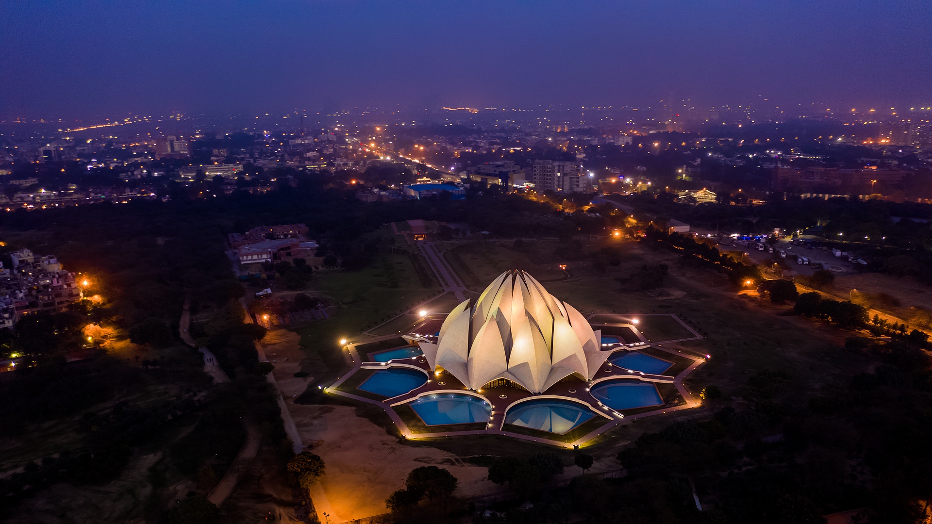 a scenic aerial night view of the Lotus Temple in New Delhi, India