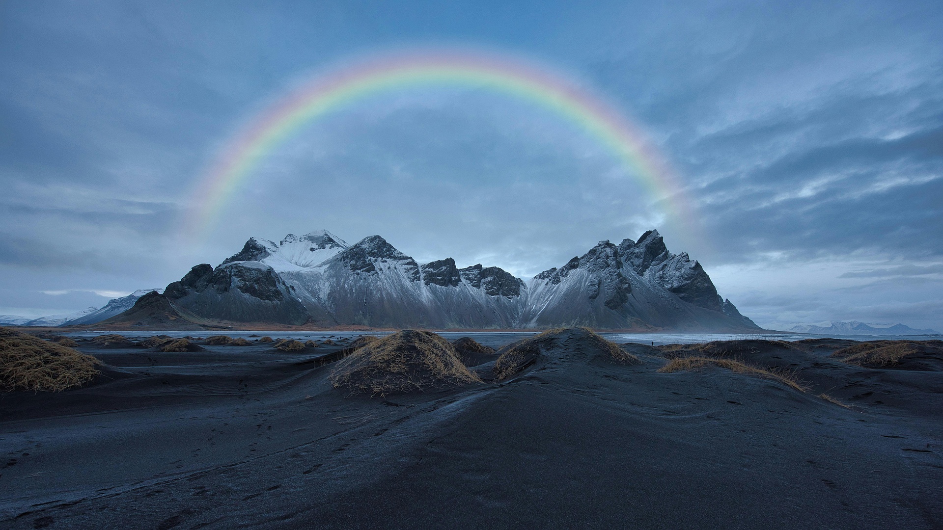 Rainbow over snow-covered mountains