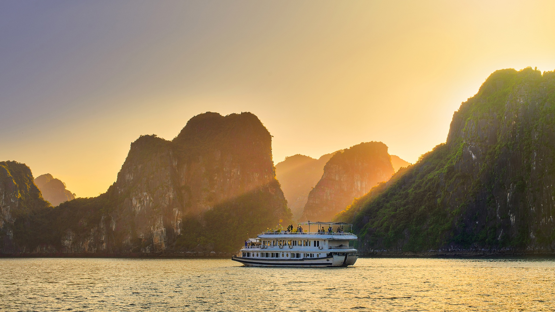 a cruise boat navigating the waters of Hạ Long Bay, Vietnam