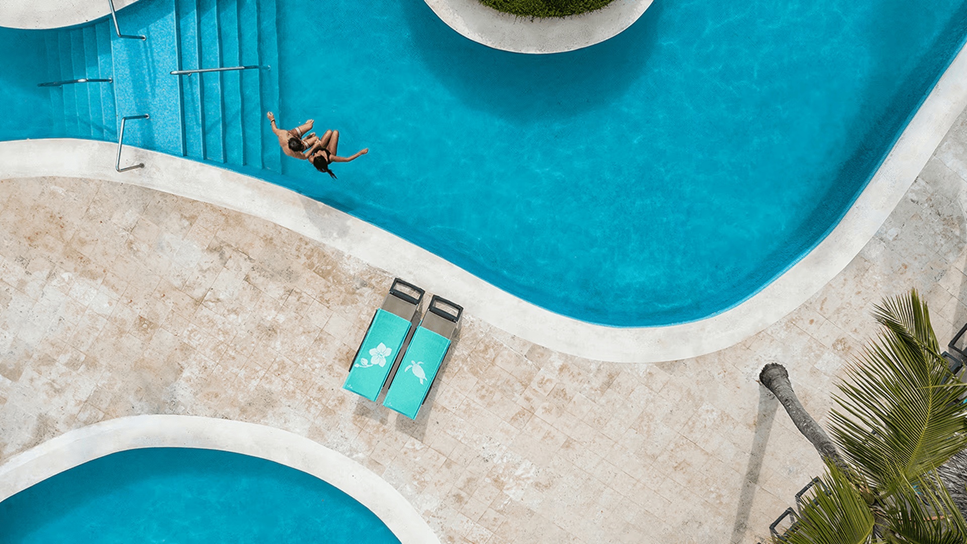 the Iberostar Waves Punta Cana resort, showcasing its large swimming pool and tropical landscaping