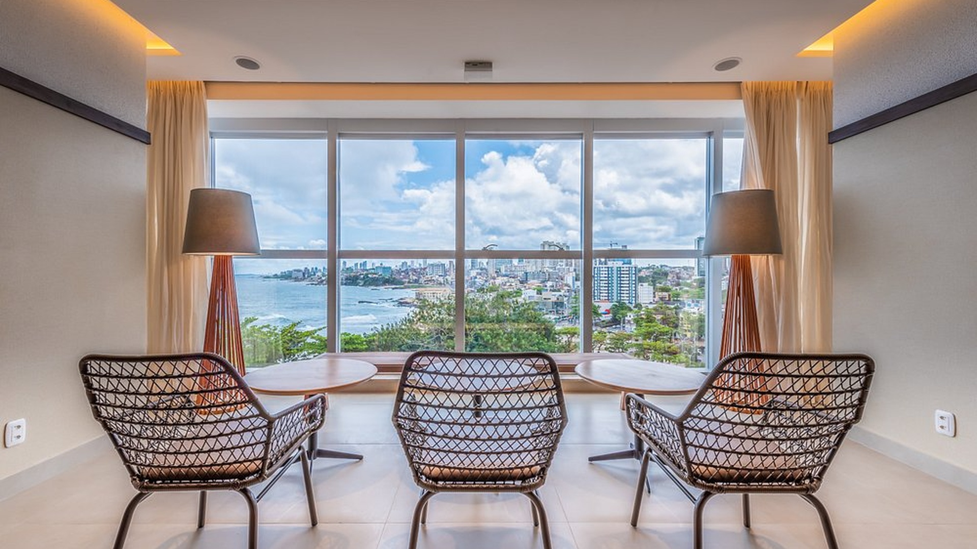 a modern hotel room interior with a scenic ocean view at the Novotel Salvador Rio Vermelho in Brazil