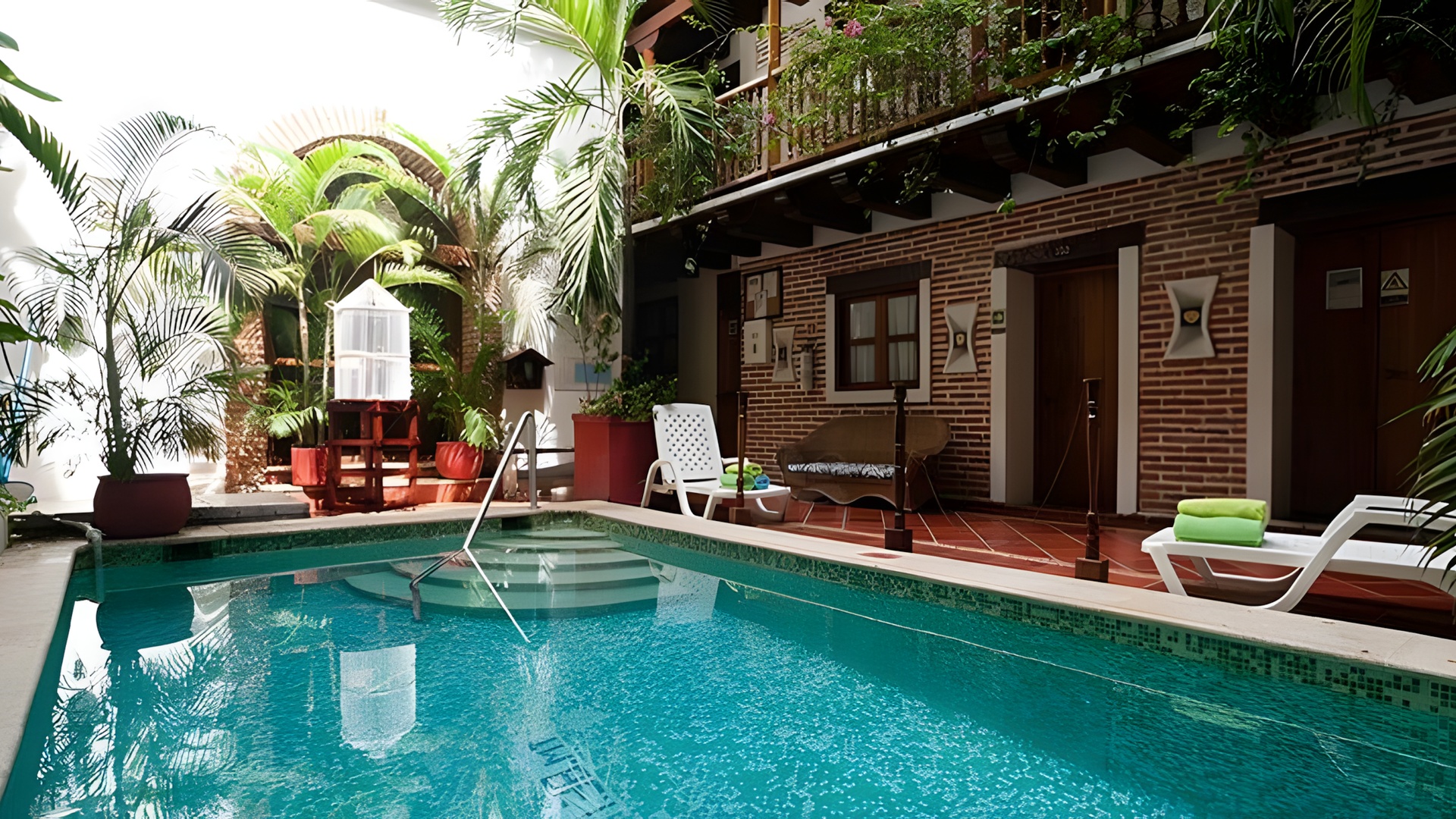 the courtyard and swimming pool area of a hotel or similar residential building