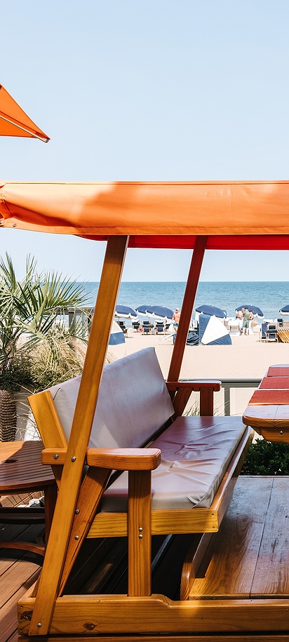 a custom wooden beach-swing dining booth