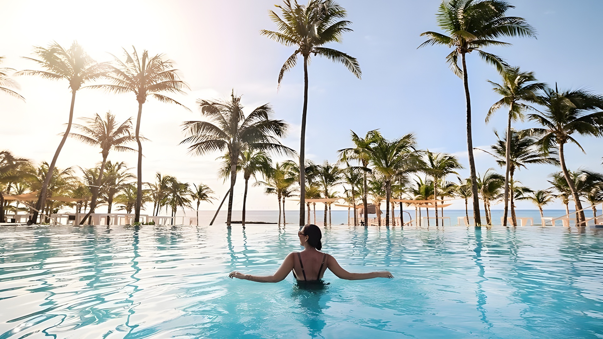 Woman enjoying pool at The Fives Oceanfront Riviera Maya