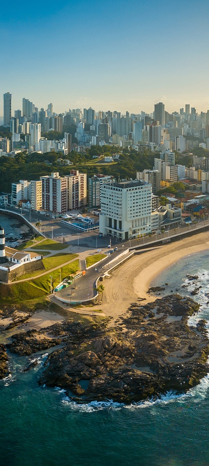 aerial view captures the Farol da Barra lighthouse and beach area in Salvador, Bahia, Brazil