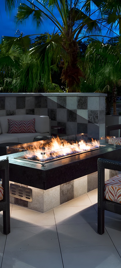 an outdoor patio featuring a fire pit and seating area at the SpringHill Suites by Marriott Lakeland
