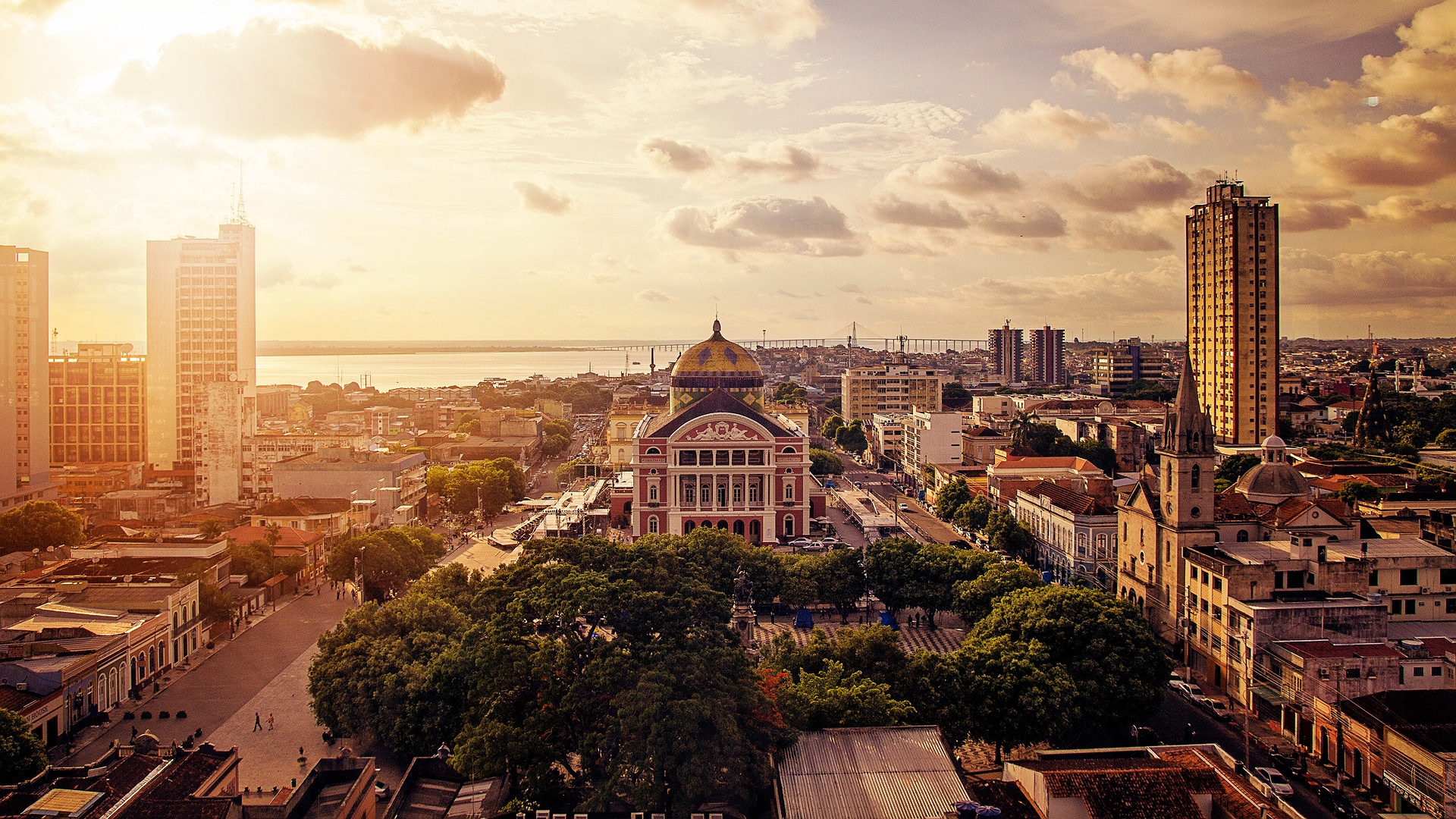 the city of Manaus, Brazil, highlighting the historic Amazon Theatre and the Rio Negro in the background