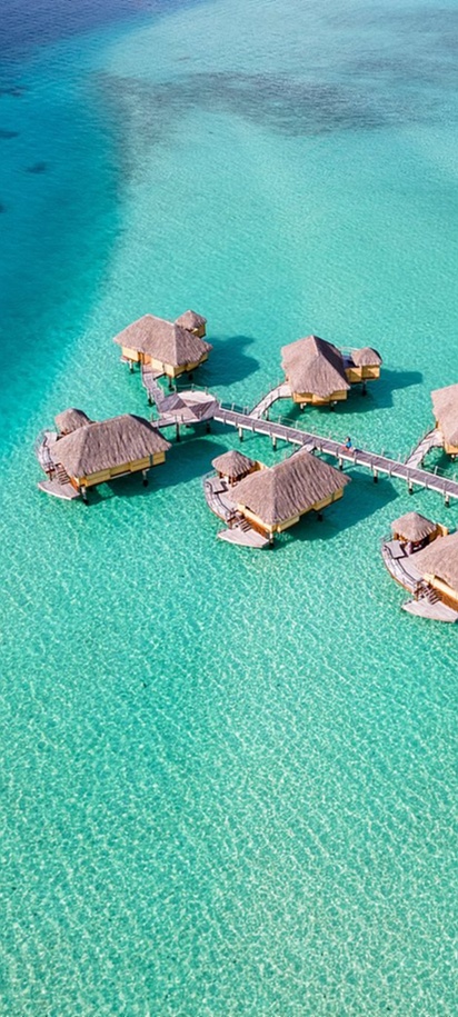 Overwater villas above clear turquoise lagoon